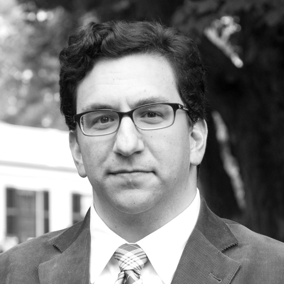 Black and white headshot of Derek Miller outside